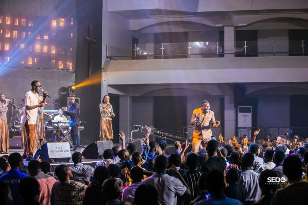Pastor Epa leading worship before a packed crowd at Power Encounter